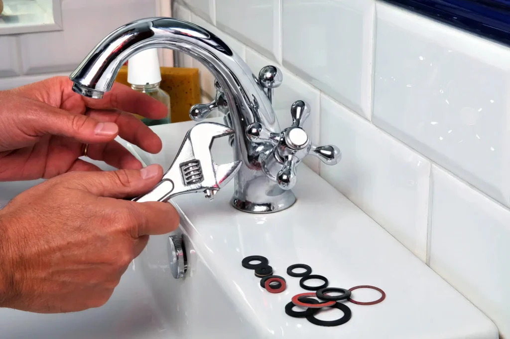 Plumber performing maintenance on a bathroom faucet in Vancouver