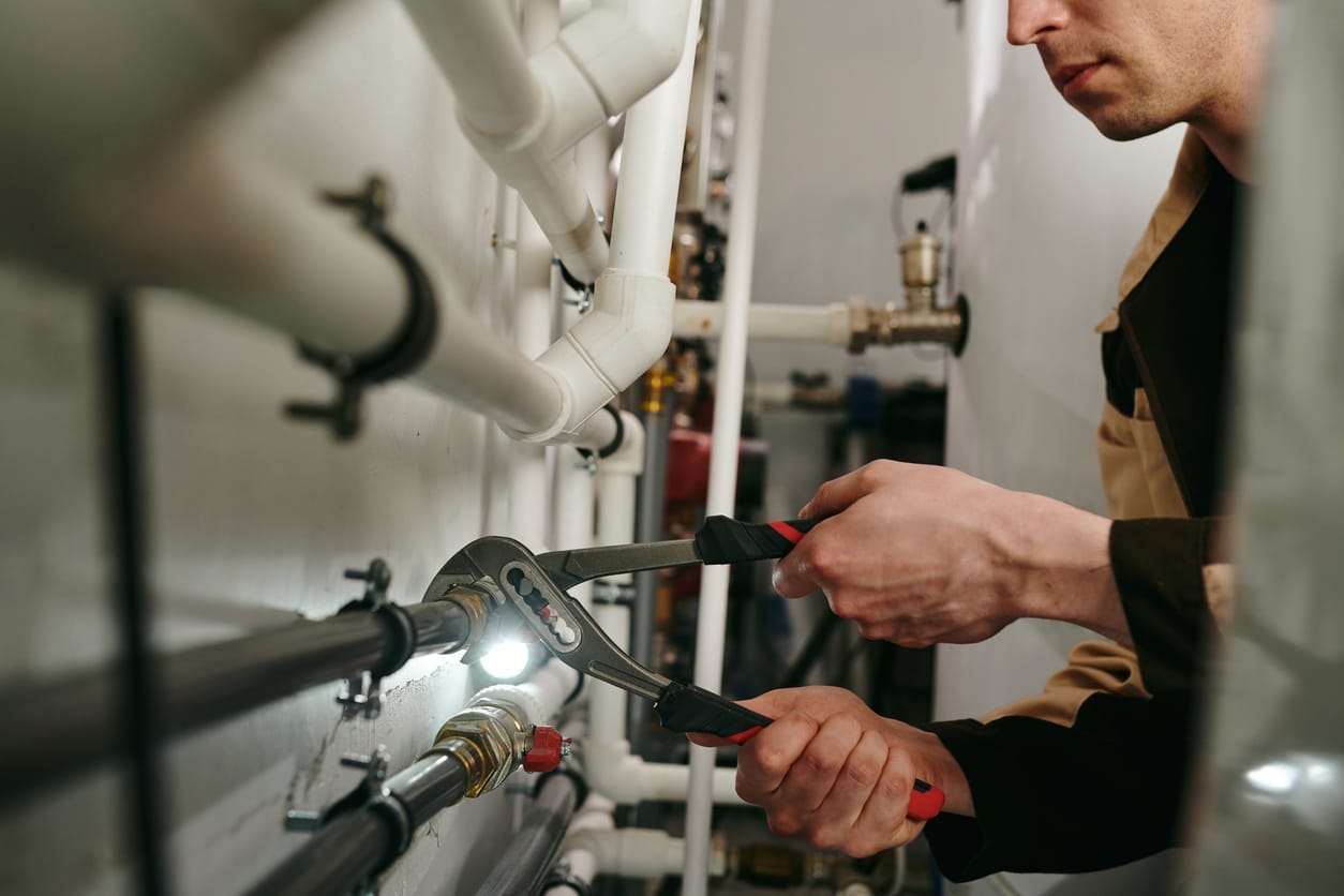 Plumbers maintaining commercial plumbing pipes in Vancouver