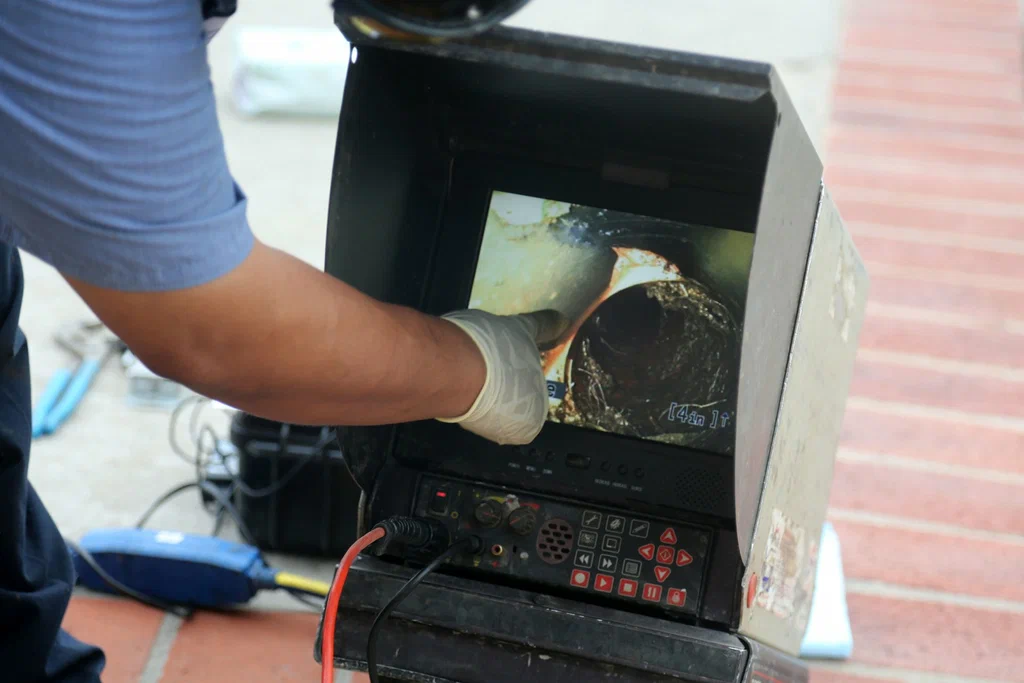 Technician viewing a drain inspection camera in Vancouver