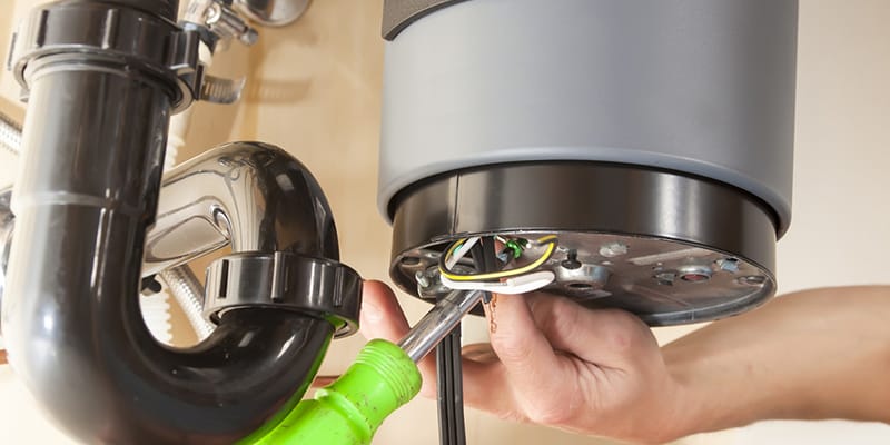 Technician repairing the heating element of a water heater in Vancouver