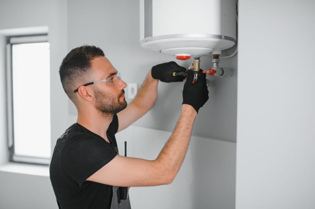 Technician performing water heater maintenance in Vancouver