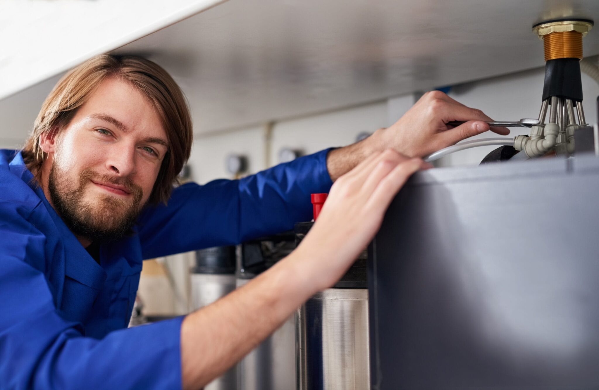 Technician servicing a residential water heater tank in Vancouver