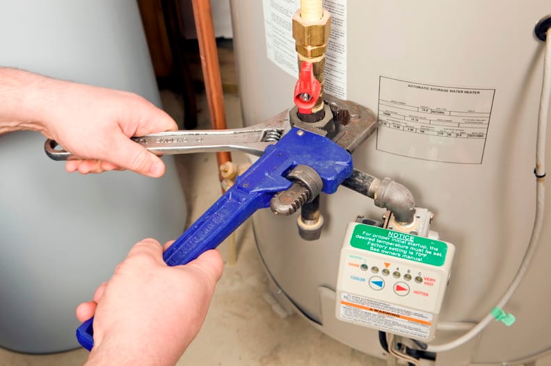 Plumber repairing a water heater valve in Vancouver